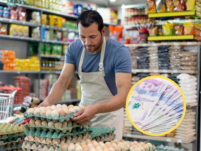 Hombre organizando unas cubetas de huevos en su negocio. En el círculo, billetes de 50 mil pesos colombianos (GettyImages)